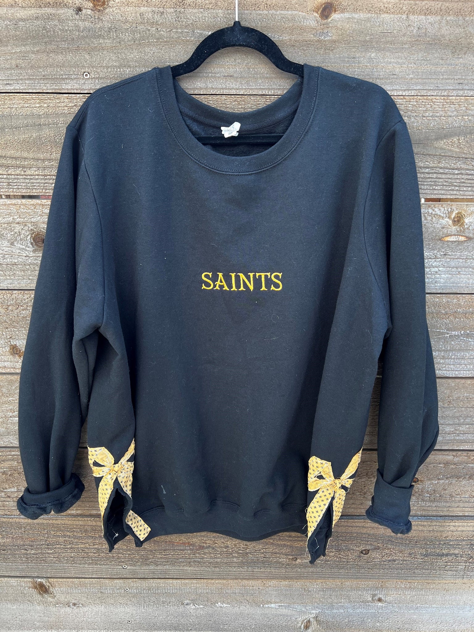 Oversized black Saints embroidered crewneck sweatshirt with split hem bows on sides ESIBOW